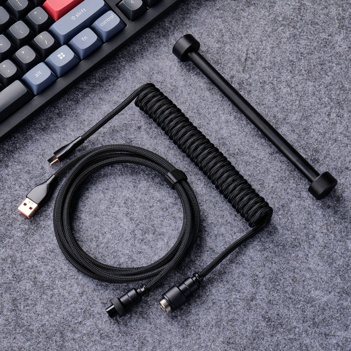 Black aviator cable arranged beside a mechanical keyboard