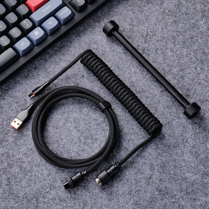 Black aviator cable arranged beside a mechanical keyboard
