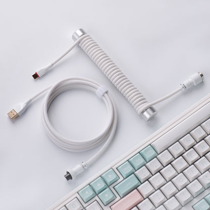 White aviator keyboard cable with silver weighted guide bar on a desk